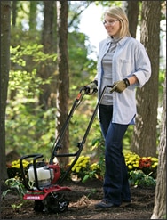 women tilling dirt with a Honda FG110 Tiller