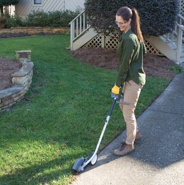 Man trimming the grass with a Honda Trimmer